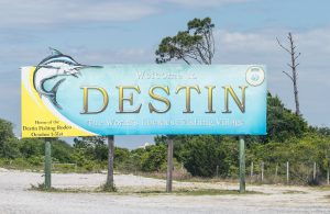 ultimate guide to destin and this photo shows the sign entering destin